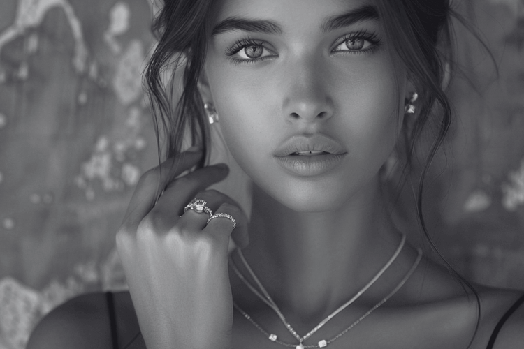 Woman wearing jewelry with a textured background