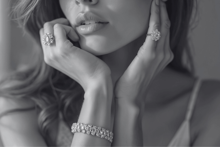 Close-up of a woman wearing diamond jewelry including earrings and a bracelet.