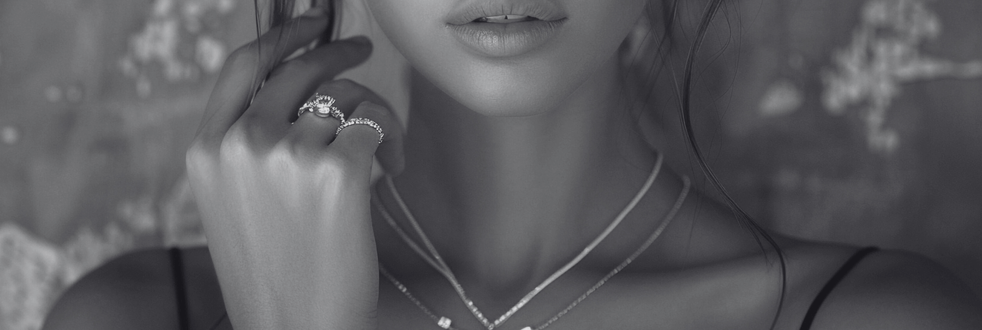 Close-up of a person wearing a necklace with a blurred background